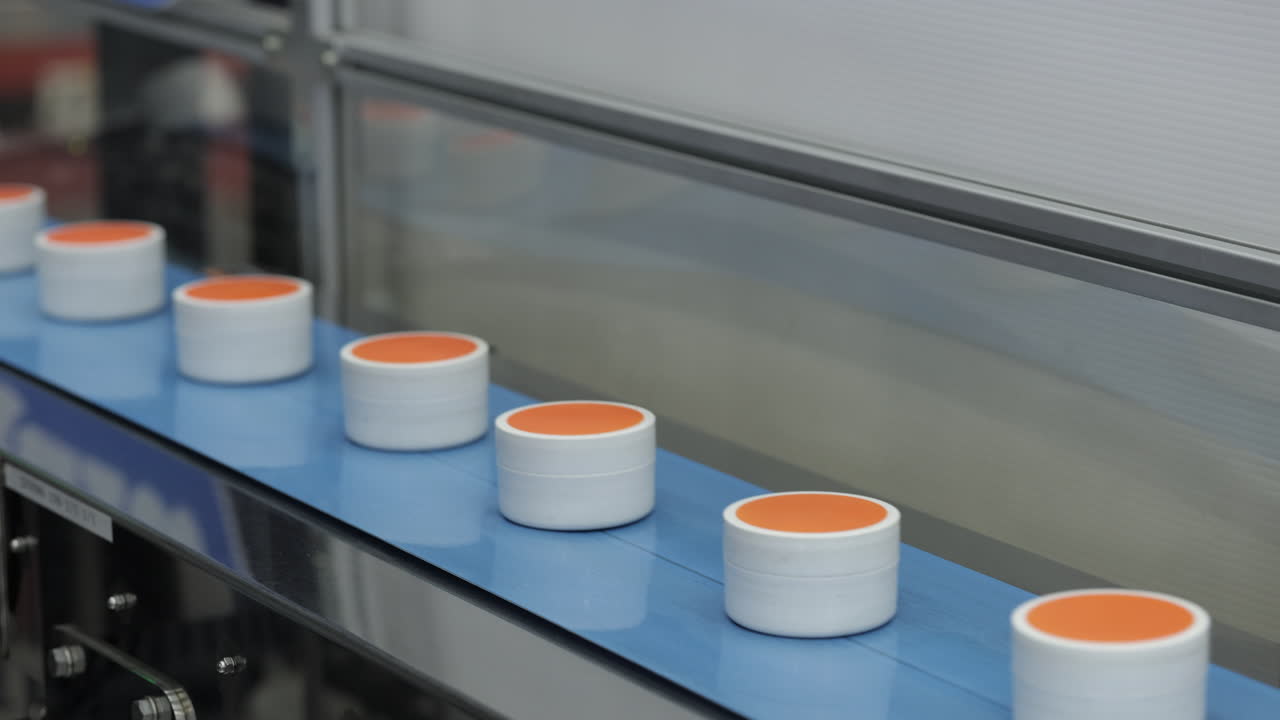 Containers on a conveyor belt in a factory