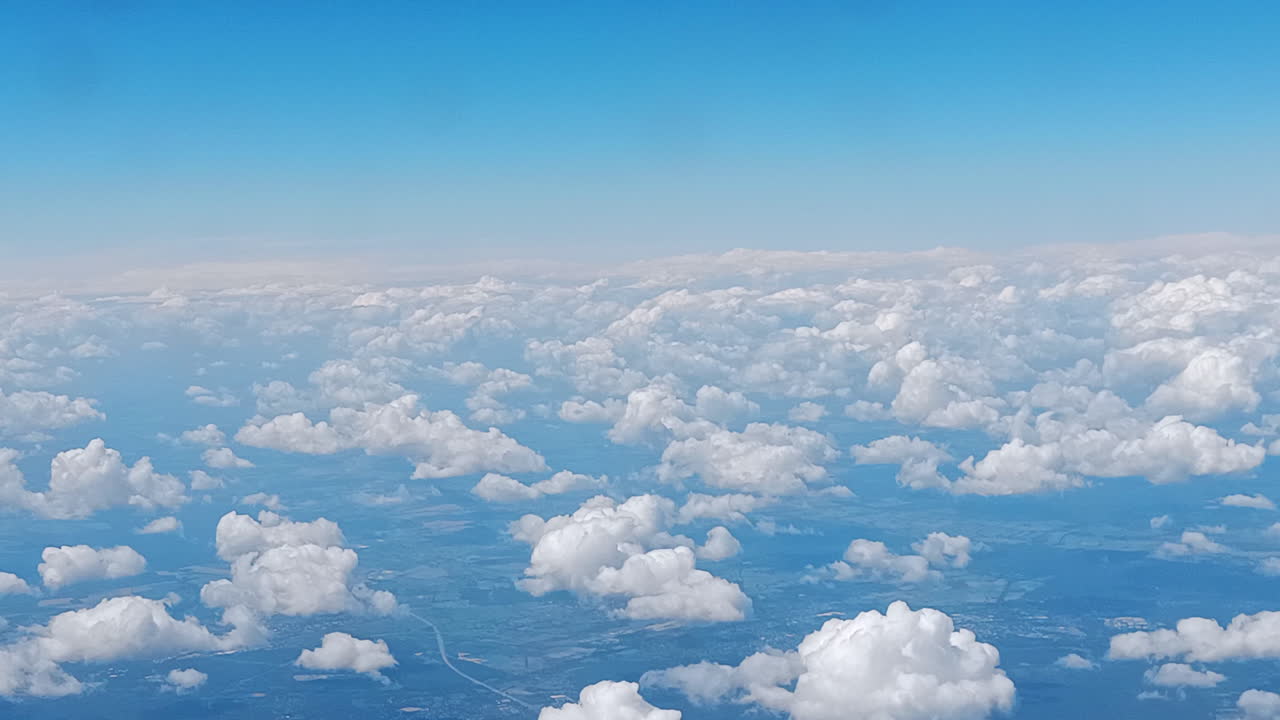Beautiful clouds whizzing by. Captured from an airplane window.