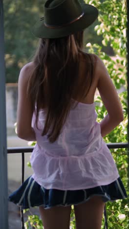 Woman in skirt on balcony