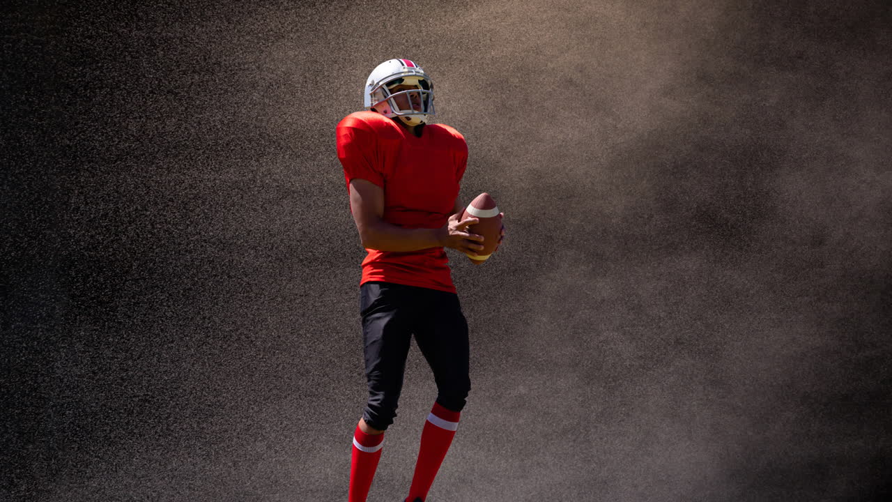 Animazione di un giocatore di football americano che tiene la palla sopra il fumo, su sfondo nero
