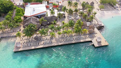 sunrise light glistens on water and tropical resort at zanzibar beach jan thiel curacao, aerial