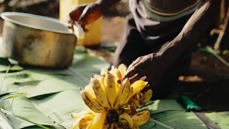 peeling bitter mbidde bananas to make tonto