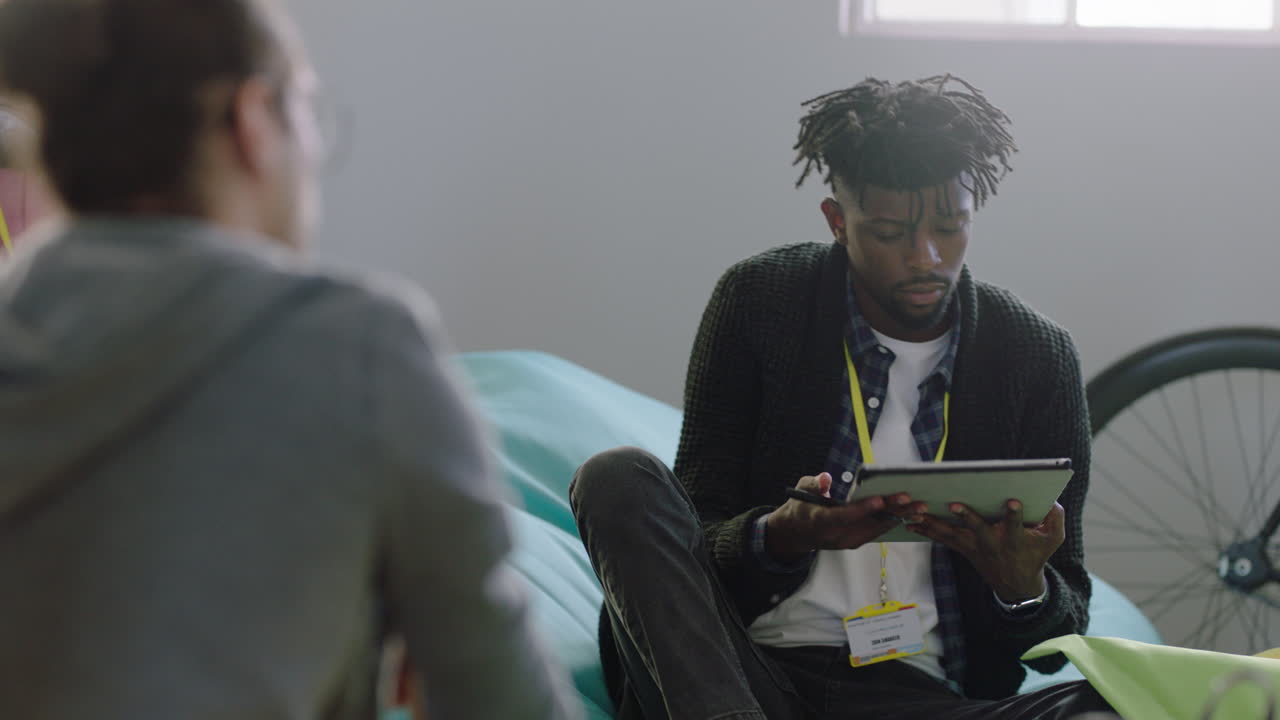 young group of business students study together using digital tablet computer working on project brainstorming sharing ideas relaxing in multi ethnic office