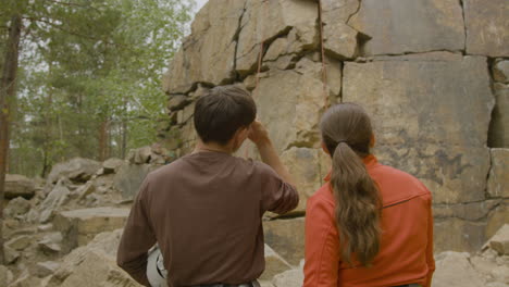 climbers at the bottom of the cliff