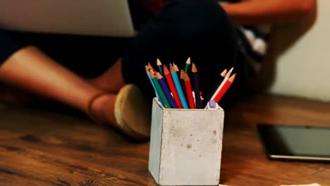 penholder and digital tablet on a wooden floor