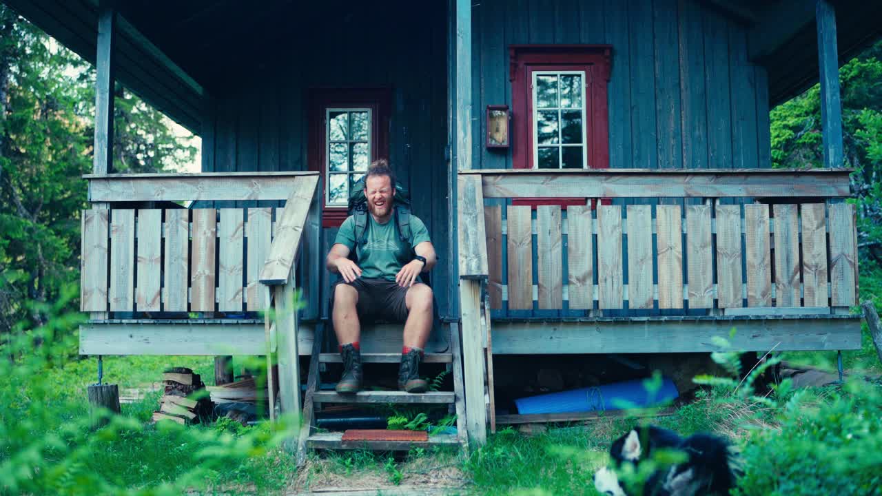Backpacker Arriving Home After Hiking Adventure In Norway. static shot