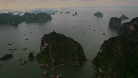 aerial circle view of headlands in the water with moored boats