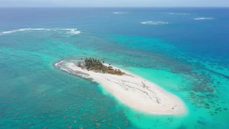 Aerial-View-of-Small-Tropical-Island-in-Tonga-Archipelago,-Polynesia,-Blue-Pacific-Ocean,-White-Sant-and-Palm-Trees,-Drone-Shot