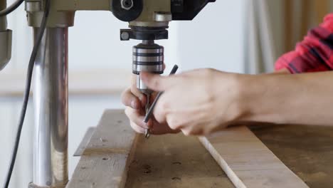 Carpenter tightening drill beat in vertical drill machine in workshop 4k