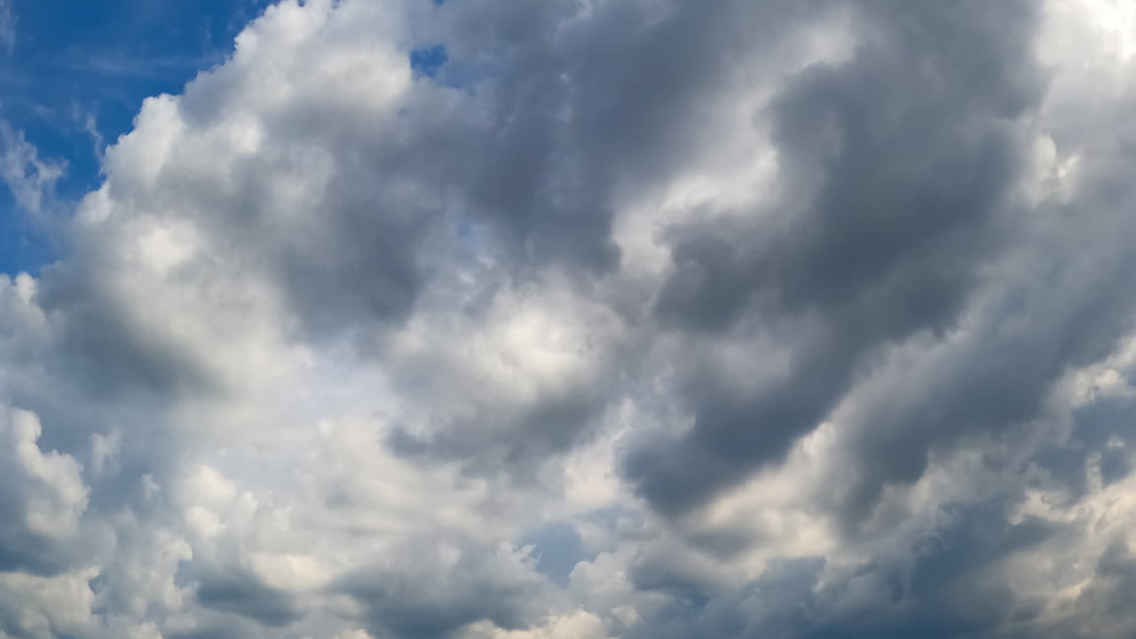 Clouds in motion timelapse. Watch as clouds shift and change in a captivating timelapse display over a blue sky throughout the day