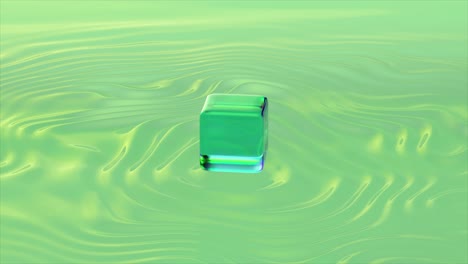 cubo iridescente verde en la superficie del líquido