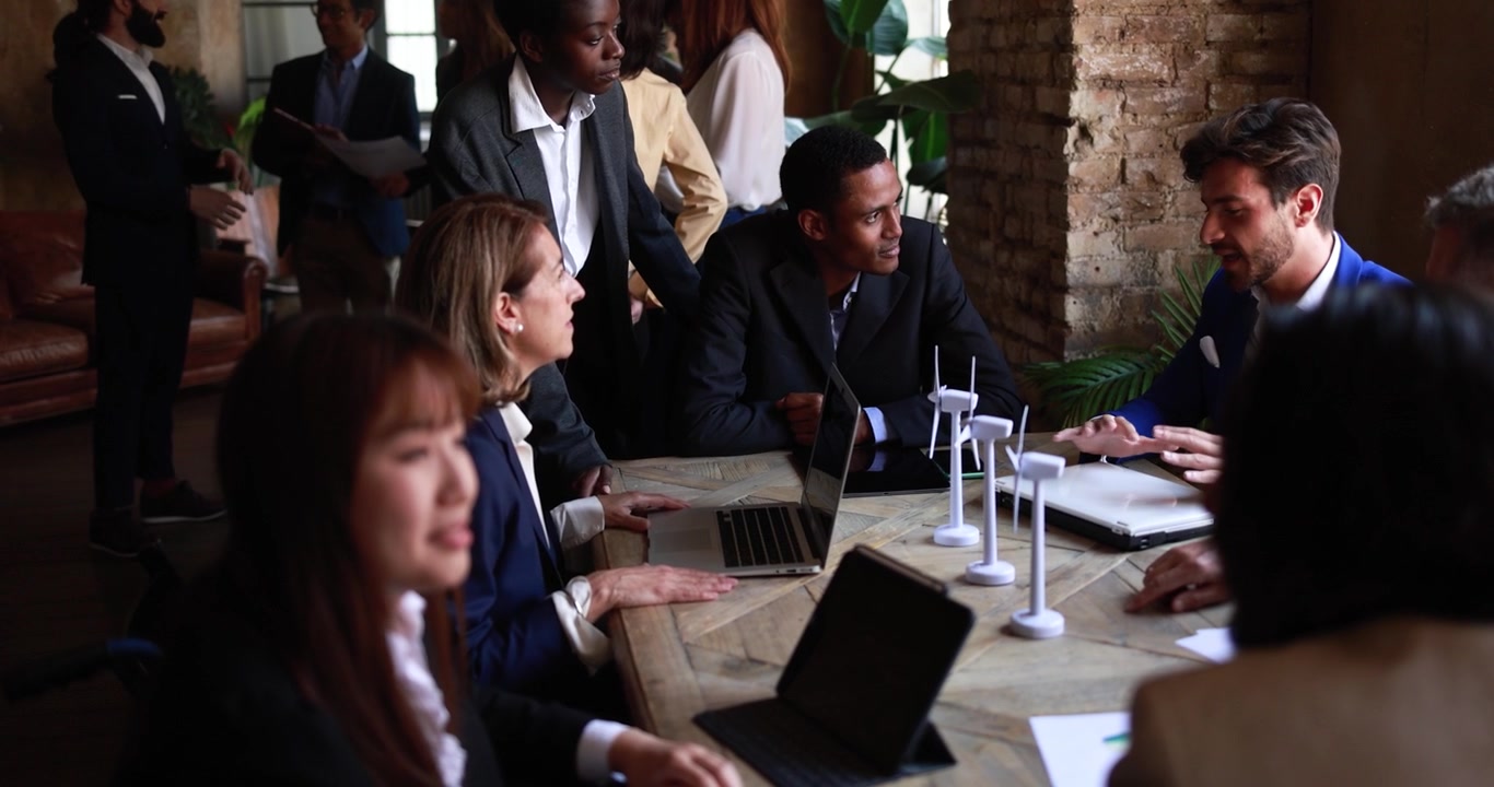 Diverse Business Team Discussing Renewable Energy Project in Office