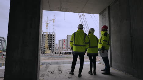 civil engineer foreman and building inspector are viewing construction site building engineers