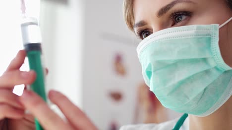 Close-up-of-female-doctor-holding-a-syringe