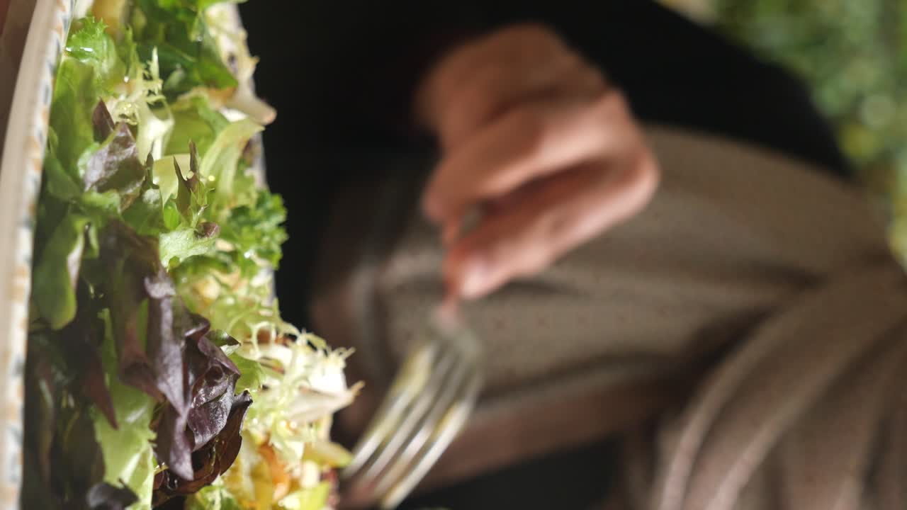Salad being eaten with a fork