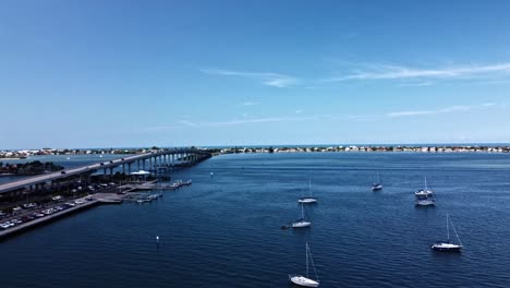 multiple vehicles are travelling on the well-known belleair causeway, which links the belleair beach islands to the florida mainland