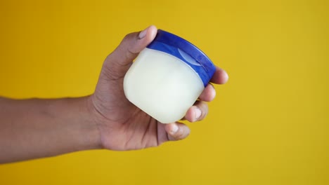 Close-up-of-man-hand-using-petroleum-jelly