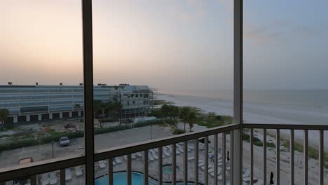 timelapse: sunrise from balcony overlooking beachside resorts and coast