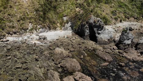 Mangawhai-Heads-aerial-shot-on-a-sunny-day,-showing-the-rocks-and-unique-terrain,-rotating-and-lock-in-an-elephant-like-rock