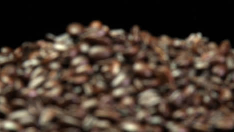 a rack focus of a pile of roasted coffee beans