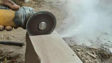 stone cutting video by hand holding cutter machine 2