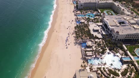 An-aerial-drone-flies-along-the-beach-of-Cabo-San-Lucas-and-of-the-resorts-along-the-beach