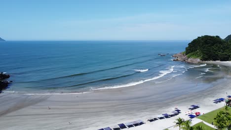 movement-ahead-on-a-small-deserted-beach-on-the-north-coast-of-São-Paulo,-calm-waves-and-lush-vegetation