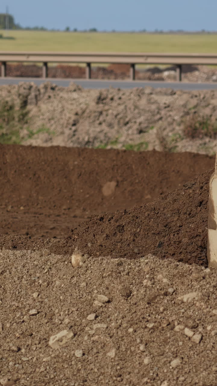 Highway Road Construction Site with Earth and Gravel Piles