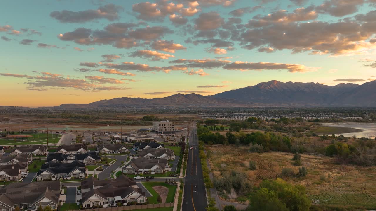 Aerial Flyover Above A Suburban Road During Sunrise In The City Of Saratoga Springs, Utah