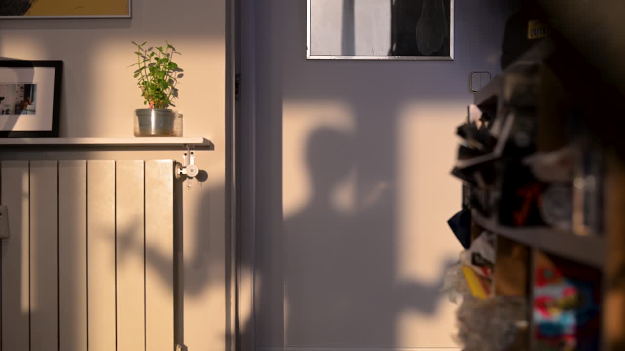 A motivational scene captures a daily fitness routine at home. The shadow of a person is seen strength training with dumbbells, embodying discipline and a commitment to a healthy lifestyle