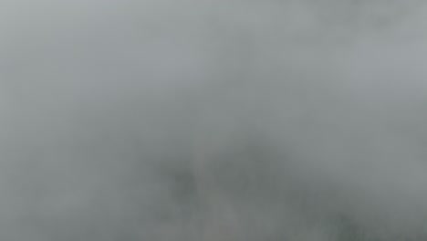 Aerial of low fog hanging over mountain and forest trees-5