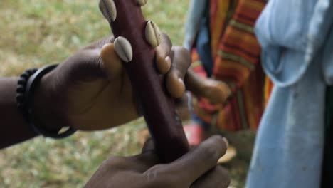 african man's hand while blowing flute, close up