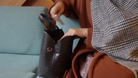 woman reaching into her handbag