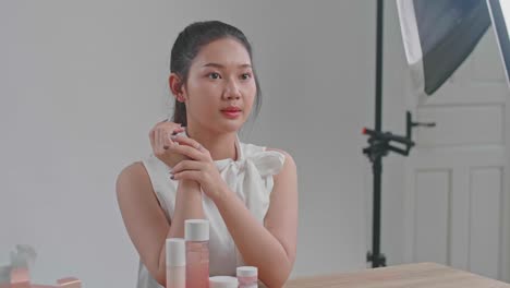 behind the scenes on photo shoot: beautiful asian model poses for a photographer