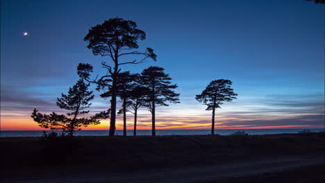 moon movement in timelapse on clear night sky after sunset over sea from the beach