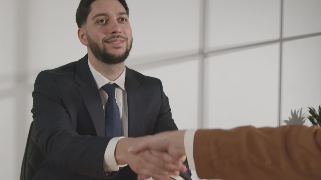 Male Candidate Shaking Hands With Female Interviewer At The End Of Job Interview Viewed Through Window 1