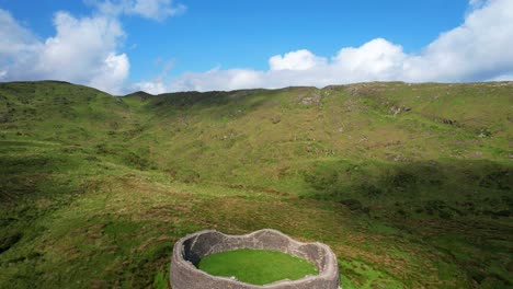 4k aerial shot reveals stone fort in iveragh peninsula, ireland