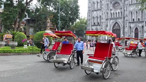 red rickshaws in front of a cathedral