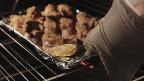 fried chicken placed inside the oven for baking - close up shot