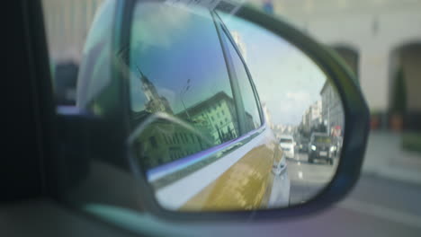 car mirror view of city street traffic