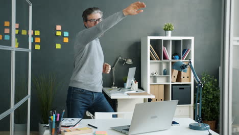 happy man dancing in office