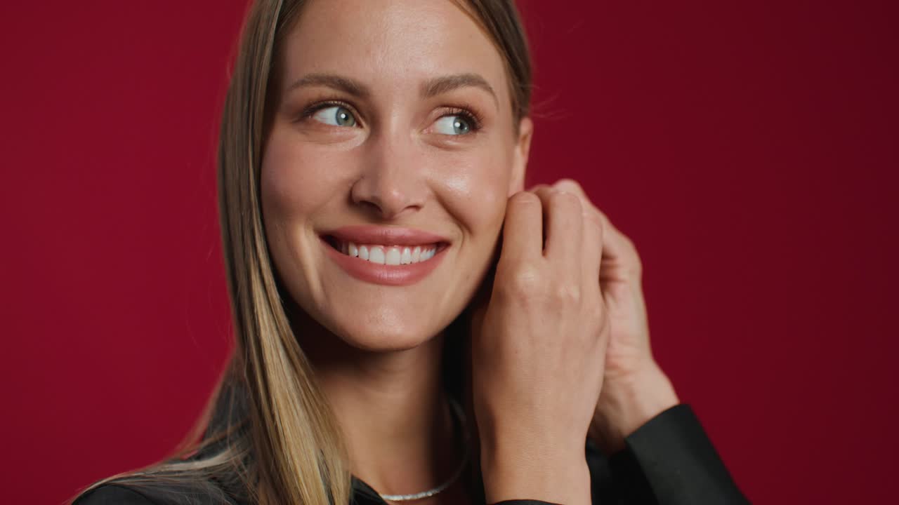 Woman Putting on Earrings