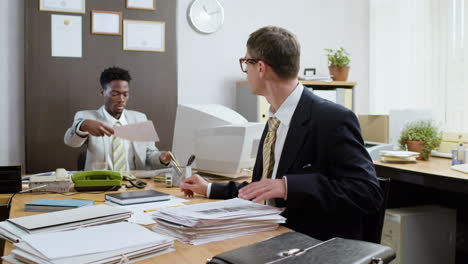 african businessman using retro computer in vintage office.