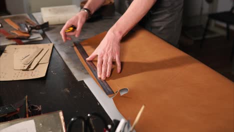 leather craftsman cutting leather