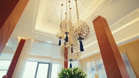 panoramic view of luxury hotel elegant chandeliers coming down the ceiling.