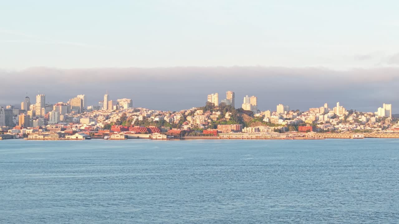 Aerial perspective highlights the geometric precision of downtown buildings hugging San Francisco’s eastern shore.