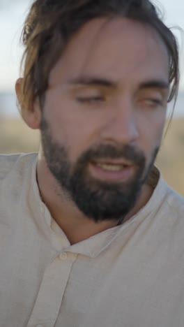 close-up portraits of a man with a beard outdoors