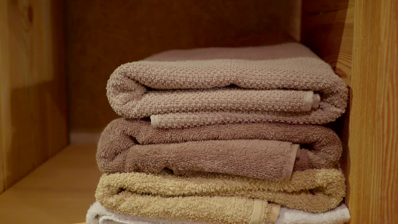 Three folded bath towels on the cabinet