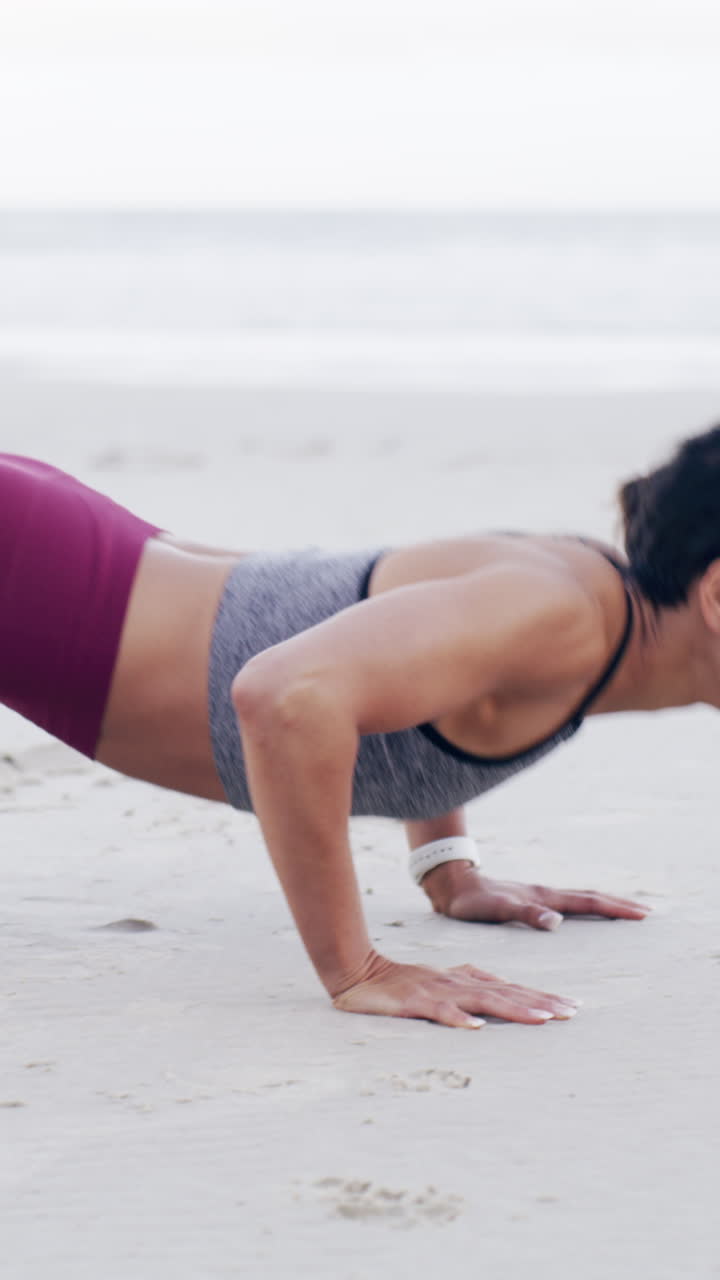 Determined Woman Doing Push-ups on a Sandy Beach
