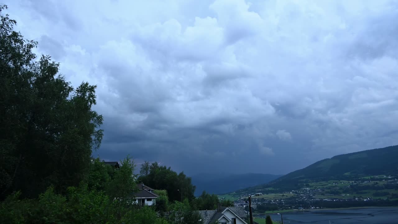 Lightning strikes and thunder echo above Voss city during intense summer thunderstorm in Norway